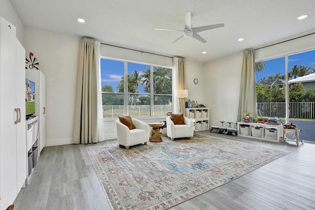 sitting room with recessed lighting, a healthy amount of sunlight, ceiling fan, and wood finished floors