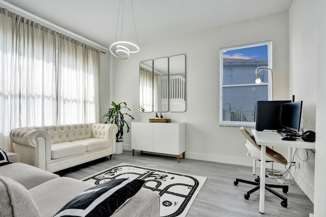office with a wealth of natural light, light wood-style flooring, and baseboards