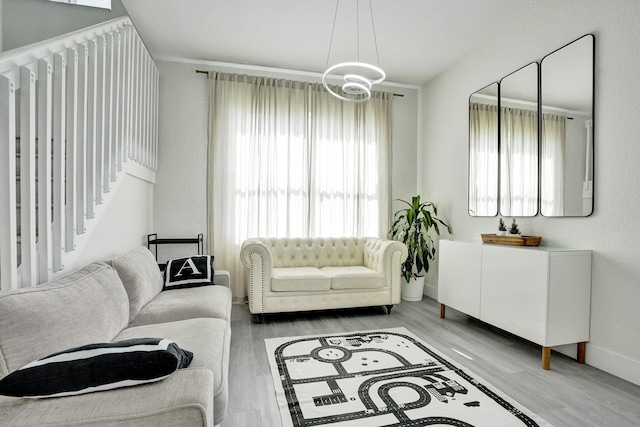 living room featuring a chandelier, wood finished floors, and baseboards