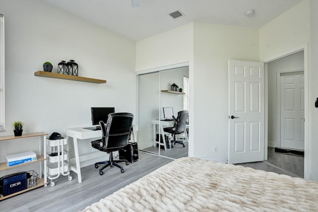 home office with visible vents and wood finished floors