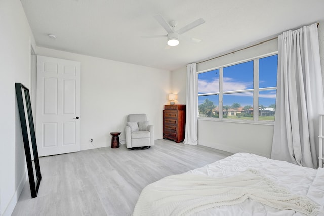 bedroom featuring baseboards, a ceiling fan, and wood finished floors