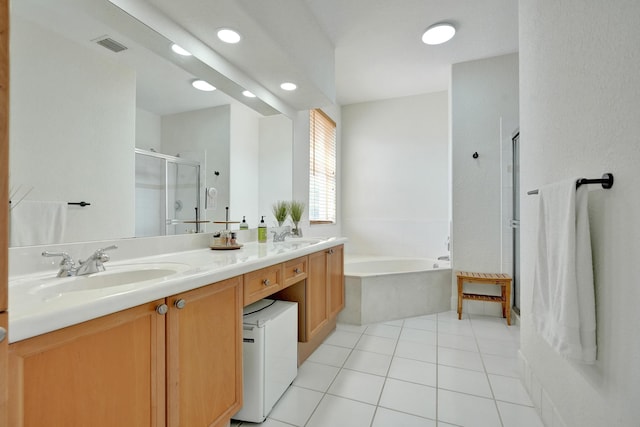 bathroom featuring a stall shower, visible vents, a bath, a sink, and double vanity