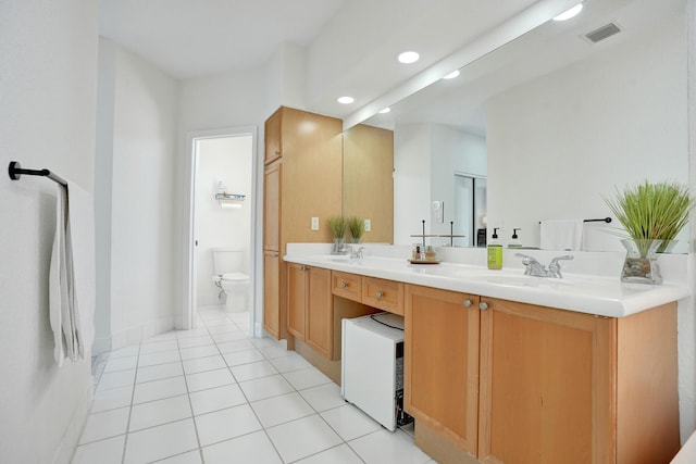 full bath featuring a sink, toilet, visible vents, tile patterned floors, and double vanity