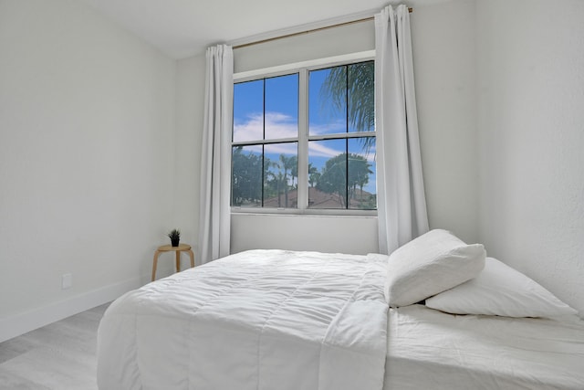 bedroom with wood finished floors and baseboards