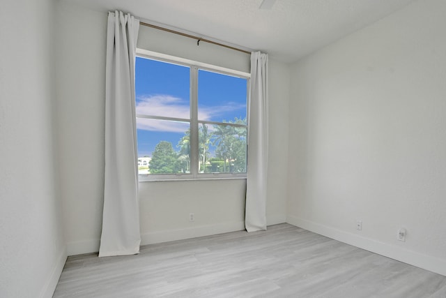 empty room with wood finished floors and baseboards