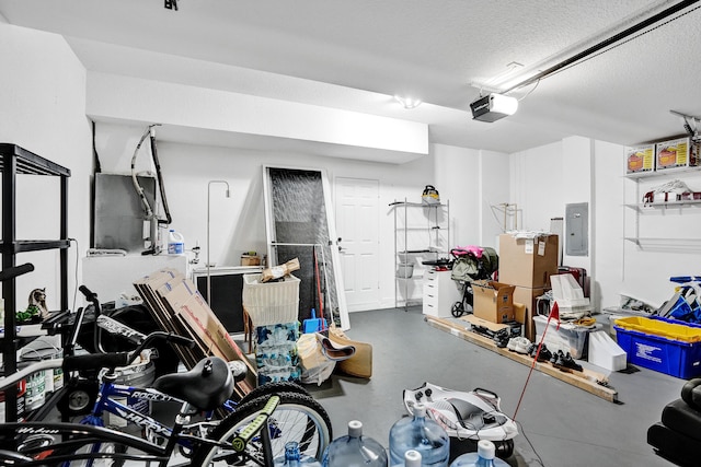 garage featuring electric panel and a garage door opener