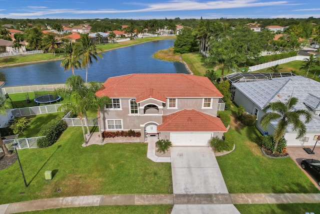 birds eye view of property with a water view and a residential view