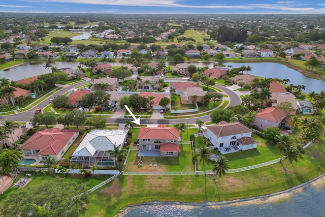 drone / aerial view featuring a water view and a residential view