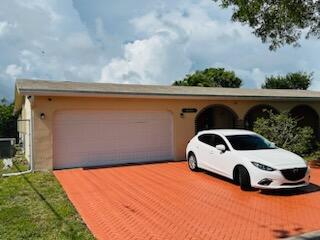 9170 NW 21st Mnr, Sunrise, FL 33322 - garage featuring driveway