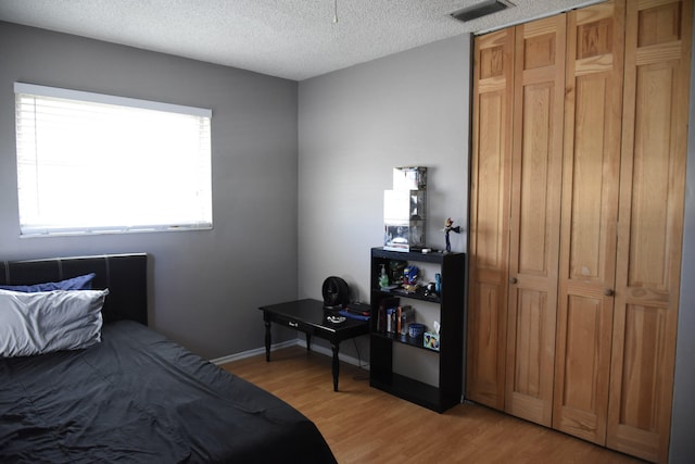 9170 NW 21st Mnr, Sunrise, FL 33322 - bedroom with light wood-type flooring and a textured ceiling
