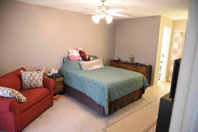 bedroom featuring light carpet and a ceiling fan
