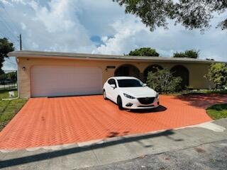 9170 NW 21st Mnr, Sunrise, FL 33322 - single story home with a garage and driveway