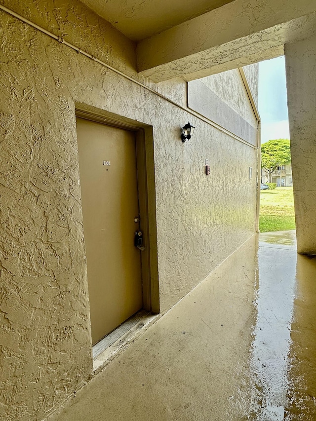 property entrance with stucco siding