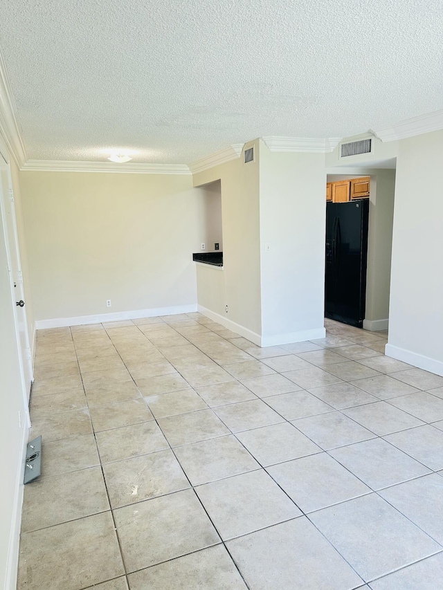 unfurnished room featuring baseboards, ornamental molding, visible vents, and a textured ceiling