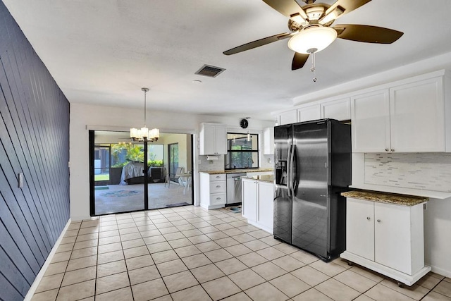 kitchen with stainless steel appliances, backsplash, white cabinetry, a chandelier, and hanging light fixtures