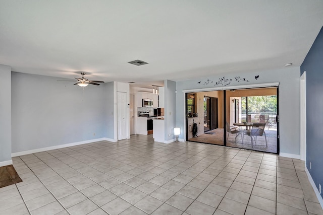 unfurnished living room with baseboards, ceiling fan, and light tile patterned floors