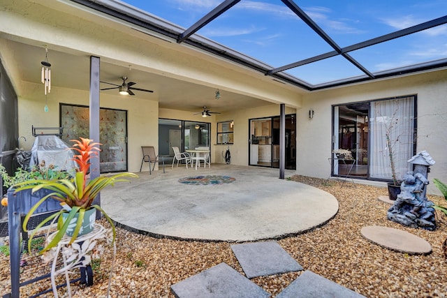 view of patio / terrace featuring ceiling fan and glass enclosure