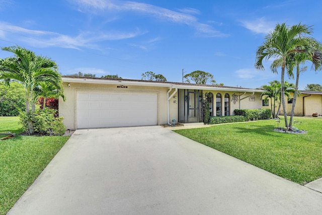 single story home with stucco siding, a garage, concrete driveway, and a front yard