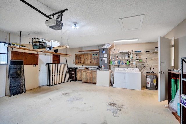 garage featuring washer and dryer, a garage door opener, water heater, and heating unit