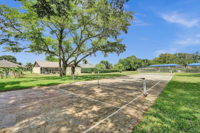 surrounding community featuring a tennis court and a yard