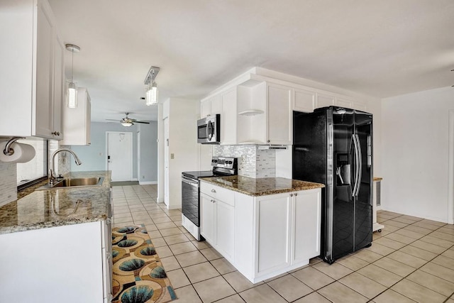 kitchen featuring stainless steel appliances, backsplash, a sink, a ceiling fan, and light tile patterned floors