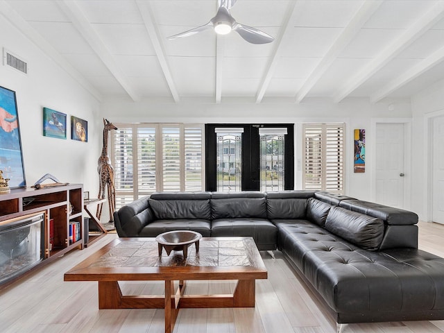 living area featuring french doors, light wood finished floors, ceiling fan, visible vents, and beamed ceiling
