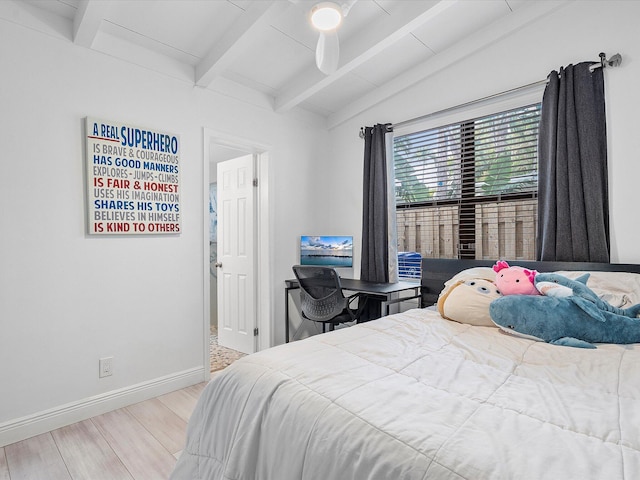 bedroom featuring wood finished floors, baseboards, lofted ceiling with beams, and ceiling fan
