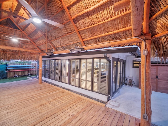 wooden terrace featuring a ceiling fan and a gazebo