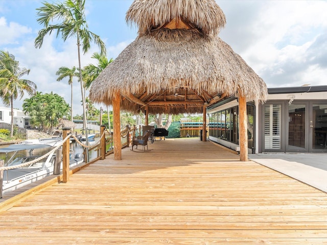 wooden deck with a gazebo and a boat dock
