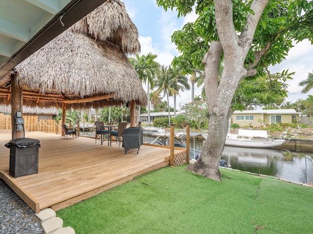 deck featuring a water view and a yard