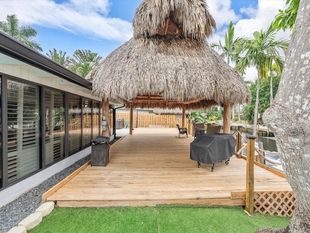 wooden terrace with fence, a gazebo, and grilling area