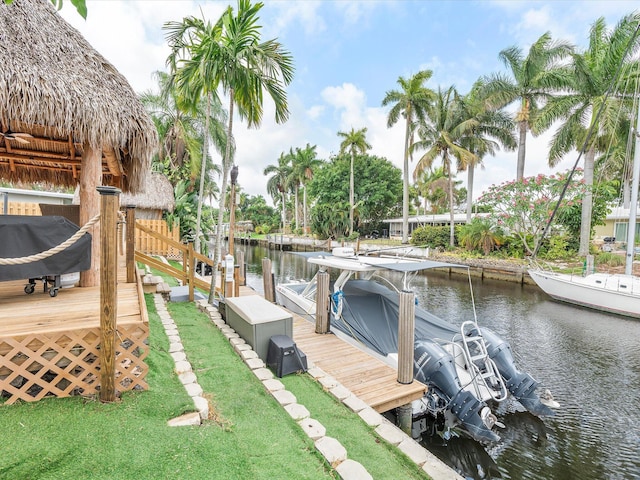view of dock with boat lift and a water view