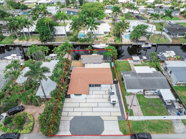 birds eye view of property with a water view and a residential view