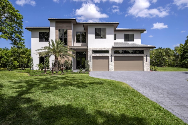 view of front of house with stone siding, stucco siding, an attached garage, and decorative driveway