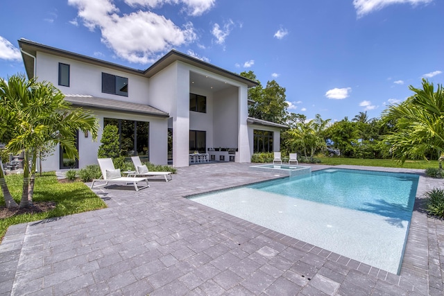 view of swimming pool with a pool with connected hot tub and a patio area