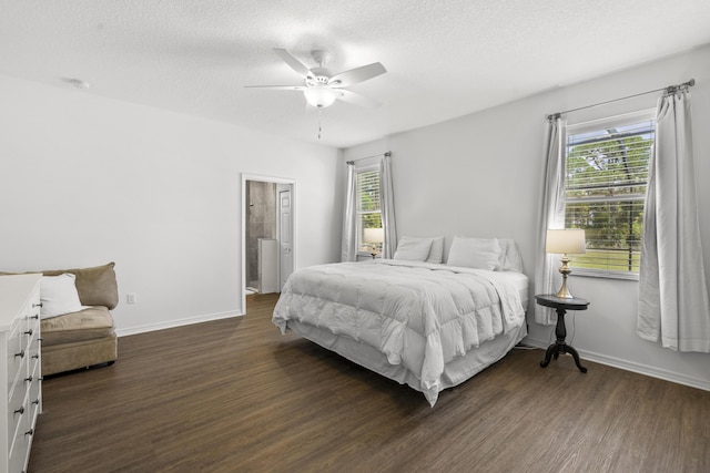 bedroom featuring dark wood finished floors, baseboards, a textured ceiling, ceiling fan, and ensuite bathroom