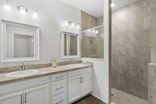 full bath with walk in shower and double vanity
