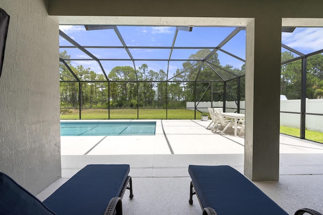 swimming pool with a patio area, glass enclosure, and a lawn