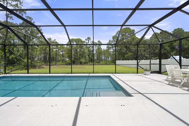 view of pool featuring a patio, a lawn, and glass enclosure