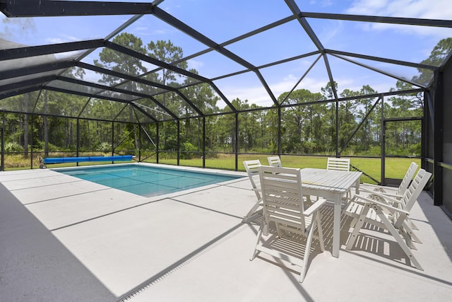 swimming pool with a patio area, a lawn, outdoor dining space, and glass enclosure