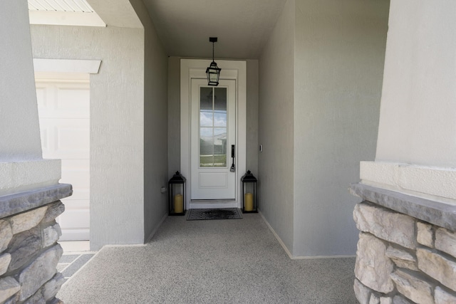 entrance to property with stucco siding