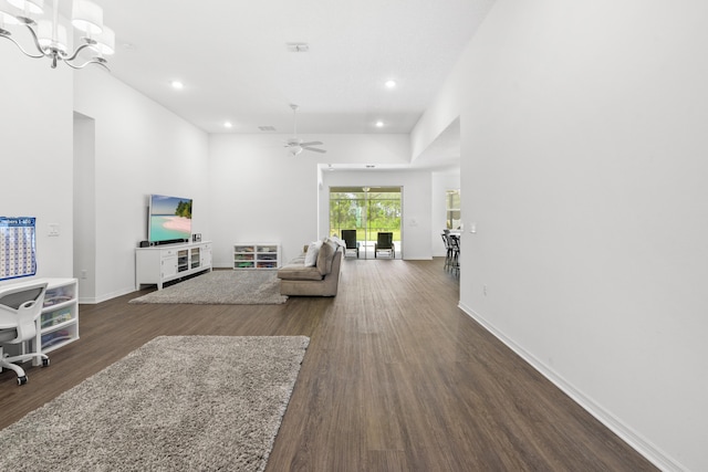 living room with dark wood-style flooring, ceiling fan, recessed lighting, baseboards, and a chandelier