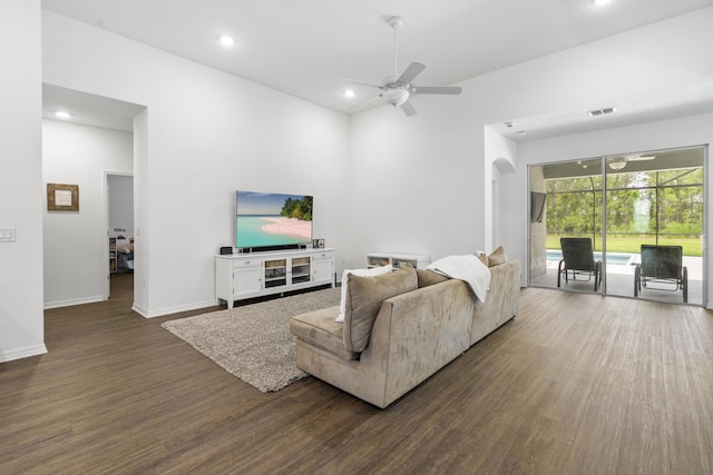 living room with ceiling fan, dark wood-style flooring, recessed lighting, arched walkways, and baseboards