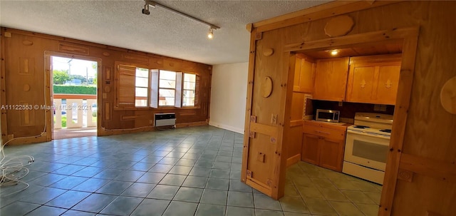 17 Brighton A 17, Boca Raton, FL 33434 - kitchen featuring white electric stove, stainless steel microwave, a textured ceiling, rail lighting, and light tile patterned floors
