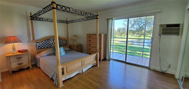 17 Brighton A 17, Boca Raton, FL 33434 - bedroom featuring access to exterior, wood finished floors, and a wall unit AC