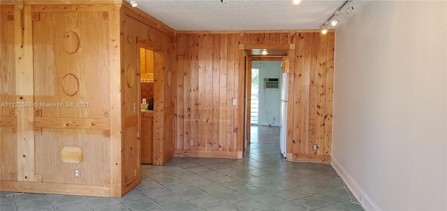 17 Brighton A 17, Boca Raton, FL 33434 - spare room with wooden walls, baseboards, a textured ceiling, track lighting, and tile patterned floors