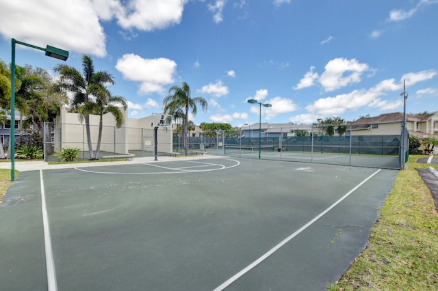view of sport court with fence, a residential view, and a tennis court