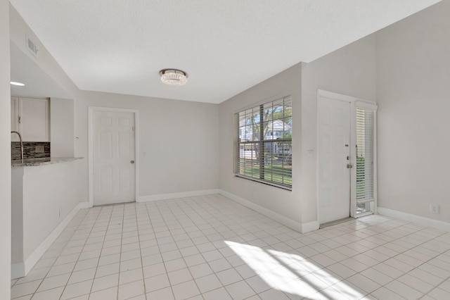 entrance foyer featuring light tile patterned floors and baseboards
