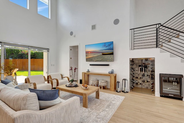 12952 Drayton Rd, North Palm Beach, FL 33408 - living room with stairway, a high ceiling, visible vents, and wood finished floors