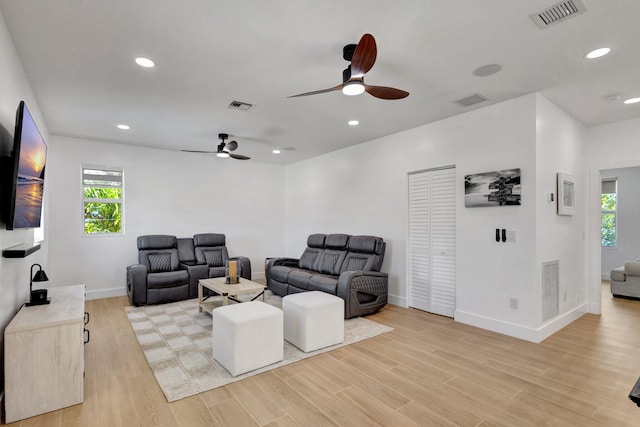 12952 Drayton Rd, North Palm Beach, FL 33408 - living room featuring visible vents, a ceiling fan, and a healthy amount of sunlight